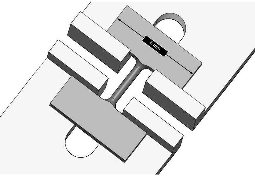 Published micro tensile test setup with a round specimen, pulling shoulders and optical imaging system used to observe specimen deformation during tensile testing.